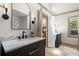 Elegant primary bathroom with stylish vanity, fixtures, and doorway to tub area at 170 Shelli Ln, Roswell, GA 30075
