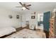 Neutral bedroom features ceiling fan, hardwood floors, area rug and gray accent chair at 170 Shelli Ln, Roswell, GA 30075