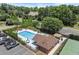 Aerial view of the community pool with lounge chairs, a gazebo, and a tennis court at 170 Shelli Ln, Roswell, GA 30075
