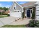 A beautifully landscaped front yard leads to this home with a large driveway and elegant front door at 170 Shelli Ln, Roswell, GA 30075