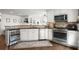 Bright kitchen features white cabinets, stainless appliances, and hardwood floors at 170 Shelli Ln, Roswell, GA 30075