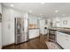 Bright kitchen with white cabinets, stainless steel appliances, granite countertops, and hardwood floors at 170 Shelli Ln, Roswell, GA 30075