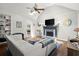 Bright living room features a fireplace, a ceiling fan, and hardwood floors at 170 Shelli Ln, Roswell, GA 30075
