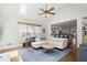 Spacious living room featuring hardwood floors, a ceiling fan, and open view to kitchen at 170 Shelli Ln, Roswell, GA 30075