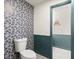 Powder room with blue striped wall paper and turquoise wainscoting at 170 Shelli Ln, Roswell, GA 30075