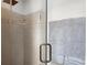 Modern shower with tile surround, glass door, and sleek fixtures at 170 Shelli Ln, Roswell, GA 30075