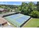 Aerial view showcases the well-maintained community tennis courts surrounded by lush greenery at 170 Shelli Ln, Roswell, GA 30075