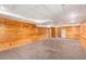 Basement featuring knotty pine walls, carpet flooring, and a white drop ceiling at 350 Dailey Mill Rd, Mcdonough, GA 30253