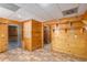Spacious basement with knotty pine walls, tiled floors, storage, and two open doorways at 350 Dailey Mill Rd, Mcdonough, GA 30253
