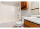 Bathroom featuring shower, toilet, and sink with wood cabinets at 350 Dailey Mill Rd, Mcdonough, GA 30253