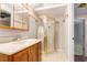 Bathroom featuring a corner shower, vanity, sink, mirror, and beige-patterned floors at 350 Dailey Mill Rd, Mcdonough, GA 30253