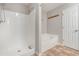 Bathroom featuring a shower, soaking tub, and neutral wall paint at 350 Dailey Mill Rd, Mcdonough, GA 30253