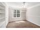 Cozy bedroom with carpet, built-in shelves, and a bright window at 350 Dailey Mill Rd, Mcdonough, GA 30253