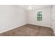 Bright bedroom featuring wall paneling and a window at 350 Dailey Mill Rd, Mcdonough, GA 30253