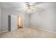 Spacious bedroom featuring gray walls, neutral carpet, and a ceiling fan with light fixture at 350 Dailey Mill Rd, Mcdonough, GA 30253