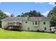 Rear exterior of a light yellow two-story home with a deck, and partially covered patio at 350 Dailey Mill Rd, Mcdonough, GA 30253