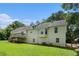 Rear exterior of a light yellow two-story home with a deck, and partially covered patio at 350 Dailey Mill Rd, Mcdonough, GA 30253