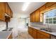 Spacious kitchen with wood cabinets, white appliances, and view of dining area at 350 Dailey Mill Rd, Mcdonough, GA 30253