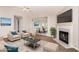 Bright living room featuring a cozy fireplace and view into the dining room, perfect for relaxation and entertaining at 350 Dailey Mill Rd, Mcdonough, GA 30253