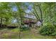 View of the back of the home from a wooded yard, showcasing a two-level deck and peaceful setting at 4098 Charlotte Se Ct, Smyrna, GA 30082