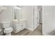Bright bathroom with modern vanity, white cabinets, updated fixtures, and luxury vinyl plank flooring at 4098 Charlotte Se Ct, Smyrna, GA 30082