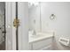 Bright bathroom with white vanity, mirror, and a classic gold towel ring at 4098 Charlotte Se Ct, Smyrna, GA 30082
