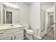 Clean bathroom featuring modern fixtures, vanity, toilet, and glass-enclosed shower at 4098 Charlotte Se Ct, Smyrna, GA 30082