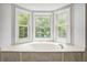 Bathroom with a soaking tub surrounded by windows providing natural light and views at 4098 Charlotte Se Ct, Smyrna, GA 30082