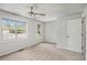 This bedroom has neutral carpet and paint with two windows that provide natural light and a ceiling fan for comfort at 4098 Charlotte Se Ct, Smyrna, GA 30082