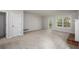 Open-concept living room featuring neutral carpet, access to the deck, and a fireplace at 4098 Charlotte Se Ct, Smyrna, GA 30082