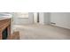 Cozy living room with neutral walls, carpeting, fireplace, and an open layout at 4098 Charlotte Se Ct, Smyrna, GA 30082