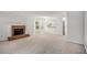 Bright living room with fireplace, carpet, bay windows, and open to kitchen at 4098 Charlotte Se Ct, Smyrna, GA 30082
