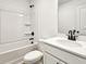 Cozy bathroom featuring a shower-tub combination and classic white vanity with a dark faucet at 685 Sunstone Ln, Lawrenceville, GA 30043