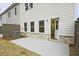 Backyard featuring a concrete patio with brick facade and view of the home's exterior at 699 Sunstone Ln, Lawrenceville, GA 30043