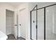 Modern bathroom featuring a glass-enclosed shower and linen closet at 699 Sunstone Ln, Lawrenceville, GA 30043