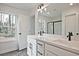 Bathroom with double vanity, quartz countertops and black hardware at 699 Sunstone Ln, Lawrenceville, GA 30043