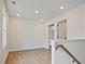 Bright hallway with hardwood floors, white walls, natural light, and access to multiple rooms at 699 Sunstone Ln, Lawrenceville, GA 30043