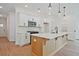 Modern open kitchen features a kitchen island with white countertops and stainless steel appliances at 699 Sunstone Ln, Lawrenceville, GA 30043