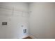 Convenient laundry room hookups with upper wire rack to maximize storage in a small space at 699 Sunstone Ln, Lawrenceville, GA 30043
