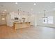 Bright, open-concept living space featuring hardwood floors and a modern island kitchen at 699 Sunstone Ln, Lawrenceville, GA 30043