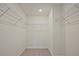 Spacious walk-in closet featuring carpet flooring and wire shelving for ample storage space at 699 Sunstone Ln, Lawrenceville, GA 30043