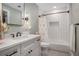 Updated bathroom featuring a tub with a tile surround, modern vanity, and stylish fixtures at 351 Prestbury Ct, Suwanee, GA 30024
