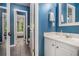 Blue bathroom with a single vanity, a framed mirror and tiled floors at 351 Prestbury Ct, Suwanee, GA 30024