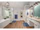 Bright bathroom features a soaking tub, glass-enclosed shower, double vanity, and a decorative lighting fixture at 351 Prestbury Ct, Suwanee, GA 30024