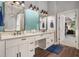 Bright bathroom featuring double vanity with granite countertops and modern fixtures with a door leading to the bedroom at 351 Prestbury Ct, Suwanee, GA 30024