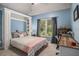 Well-lit bedroom with a built-in Murphy bed, desk, a large window, and blue accent wall at 351 Prestbury Ct, Suwanee, GA 30024