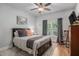Cozy bedroom with hardwood floors, a comfortable bed, large window, and tasteful decor at 351 Prestbury Ct, Suwanee, GA 30024