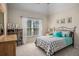 Bedroom featuring a large window, a bed with patterned bedding, and built-in shelving at 351 Prestbury Ct, Suwanee, GA 30024