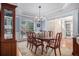 Elegant dining room features classic wainscoting, a large window, and stylish chandelier at 351 Prestbury Ct, Suwanee, GA 30024