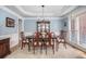 Spacious dining room with a formal table and chairs, accented by a chandelier and display cabinet at 351 Prestbury Ct, Suwanee, GA 30024